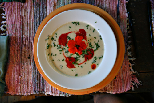 Cold potato-leek soup with chives, nasturtium, and red pepper sauce hearts